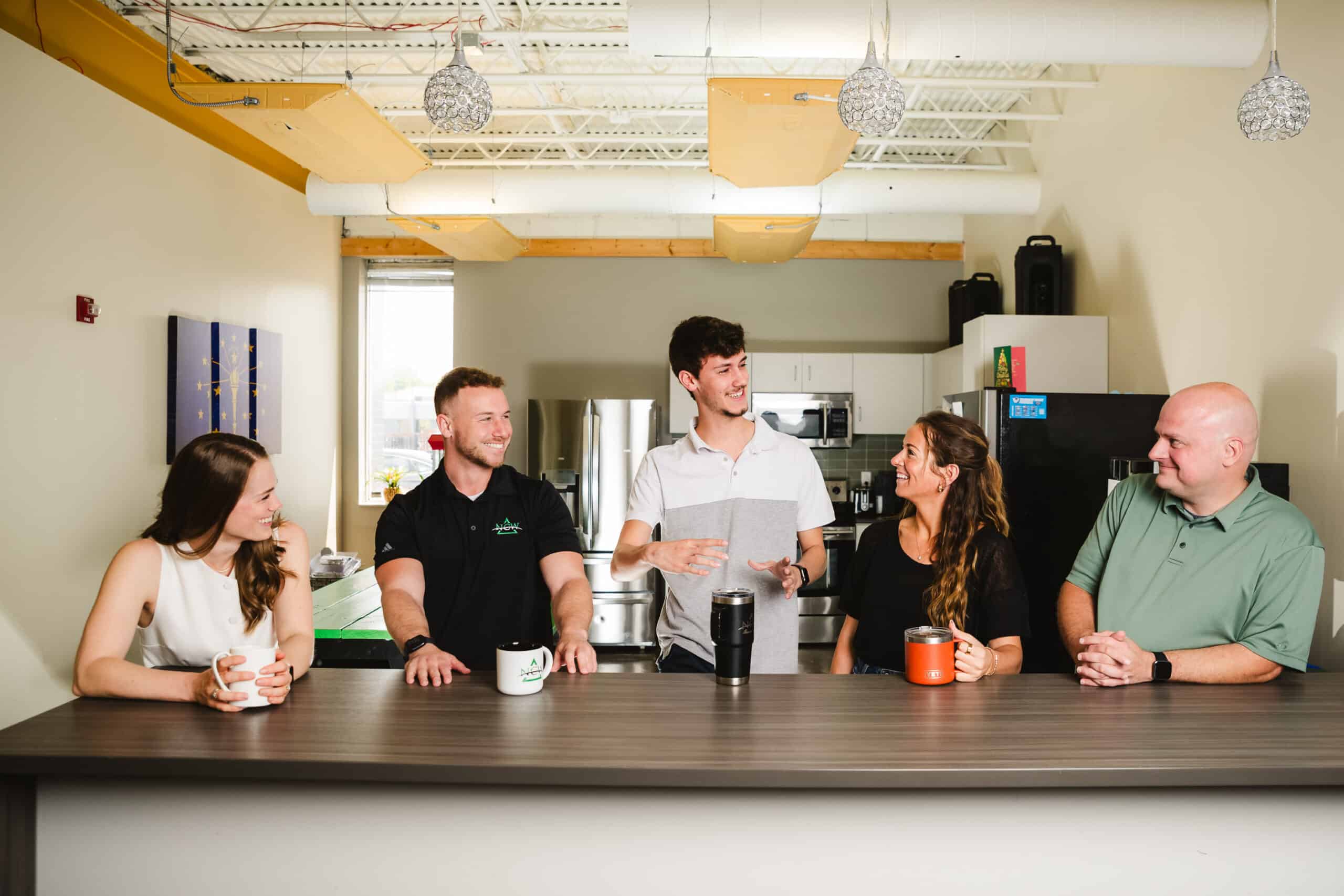 NCW employees socialize in the kitchen at the NCW office