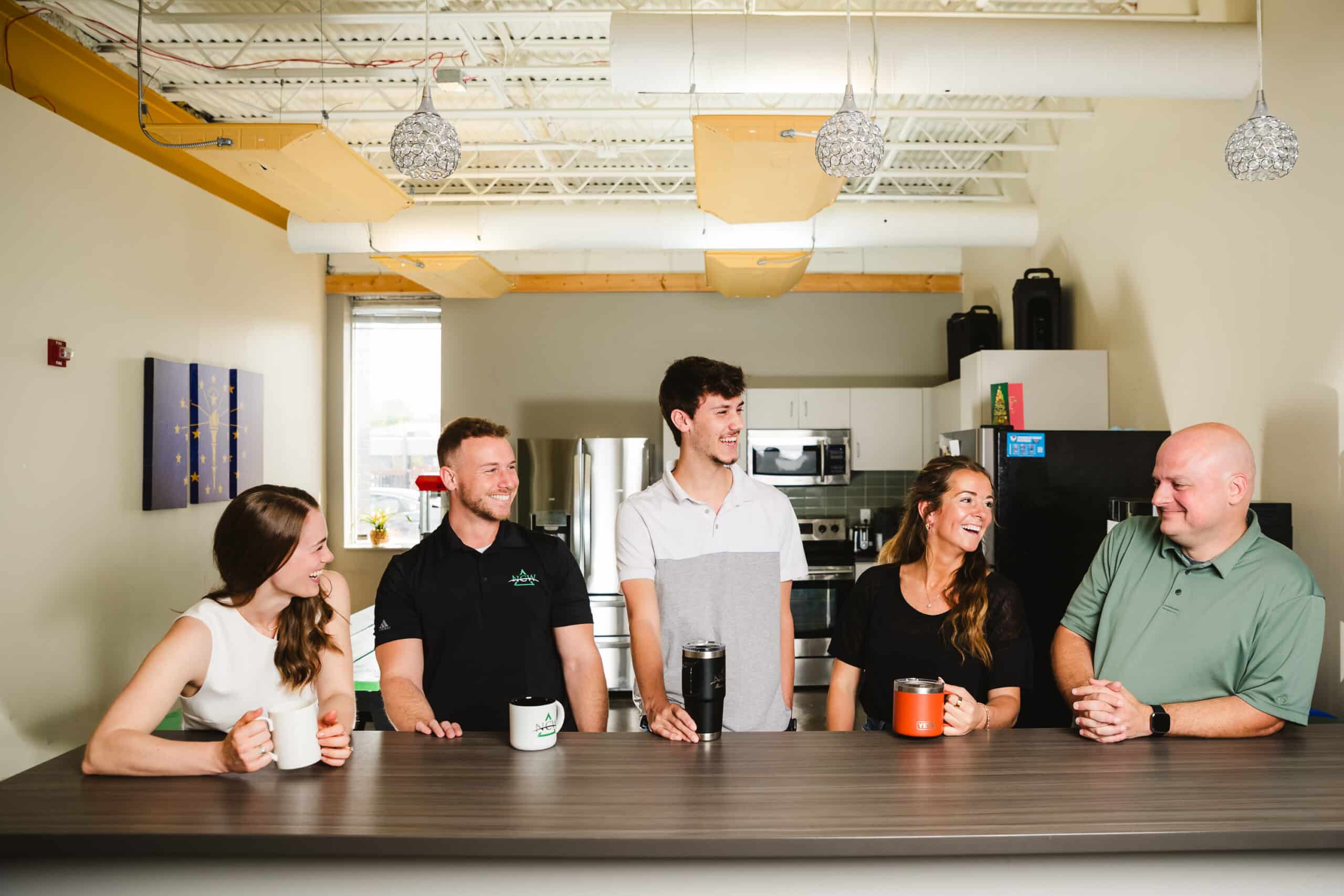 NCW employees socializing in the office kitchen