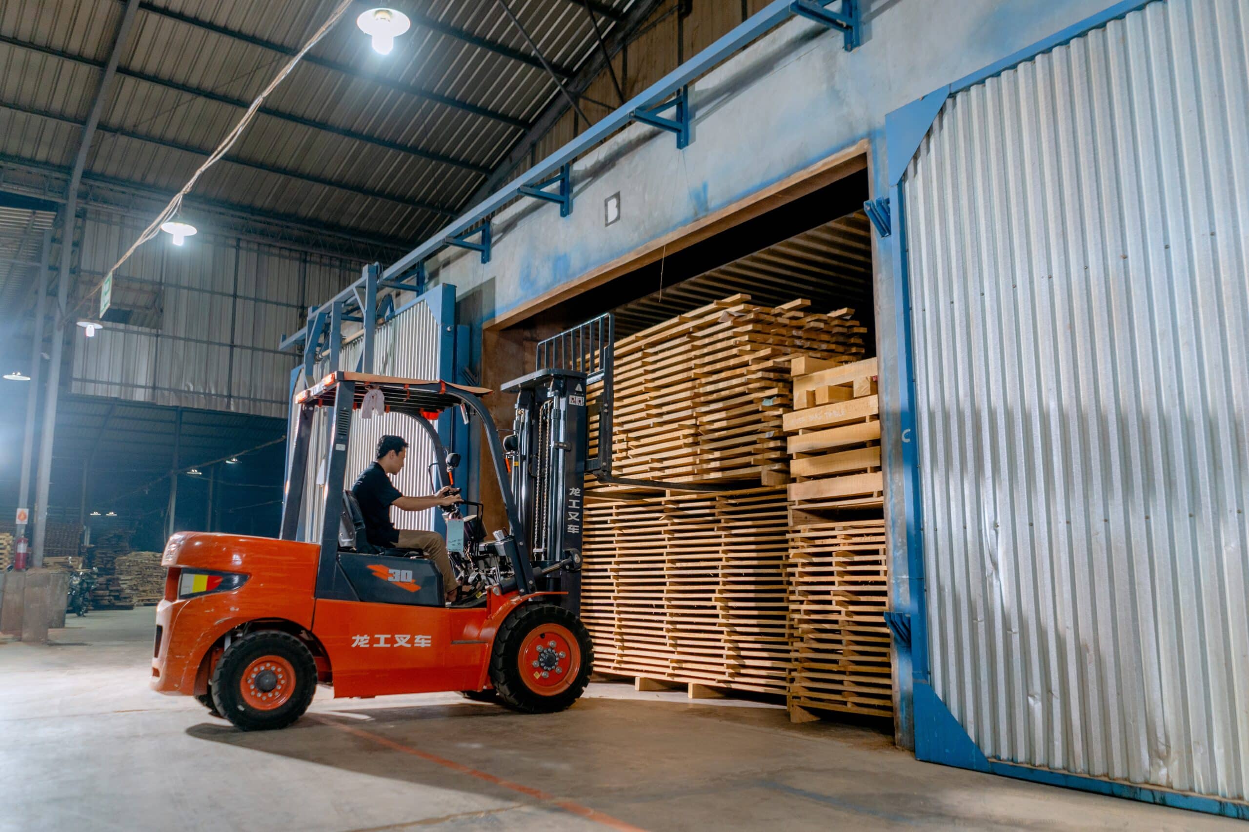 A lift operator moves pallets