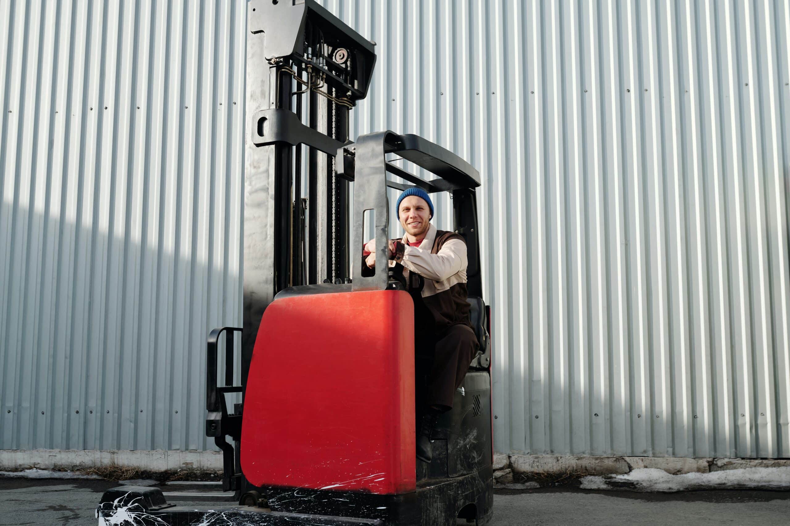 A material handler drives a forklift through the warehouse