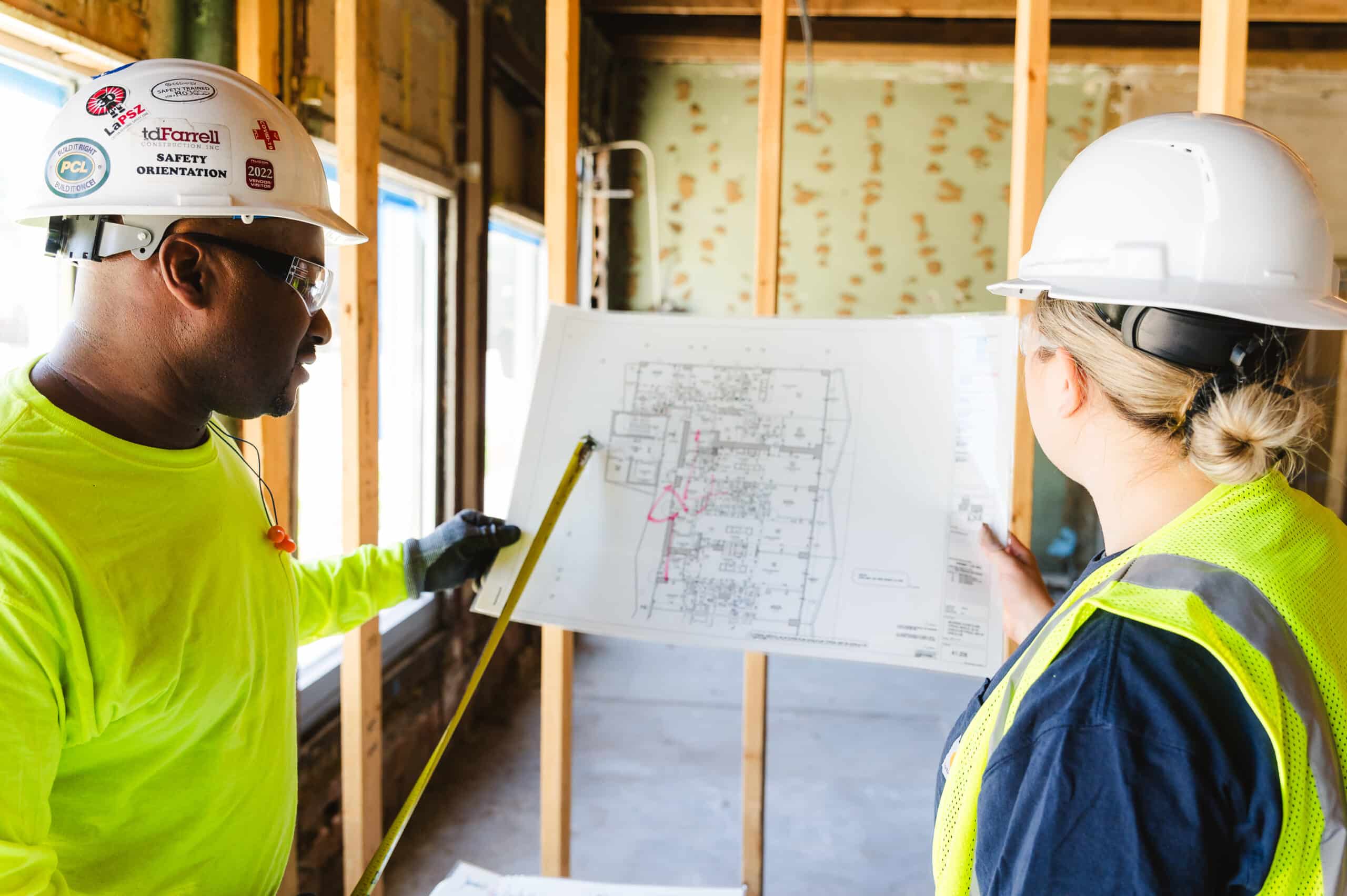 A construction superintendent briefs his construction laborer on job site tasks and expectations