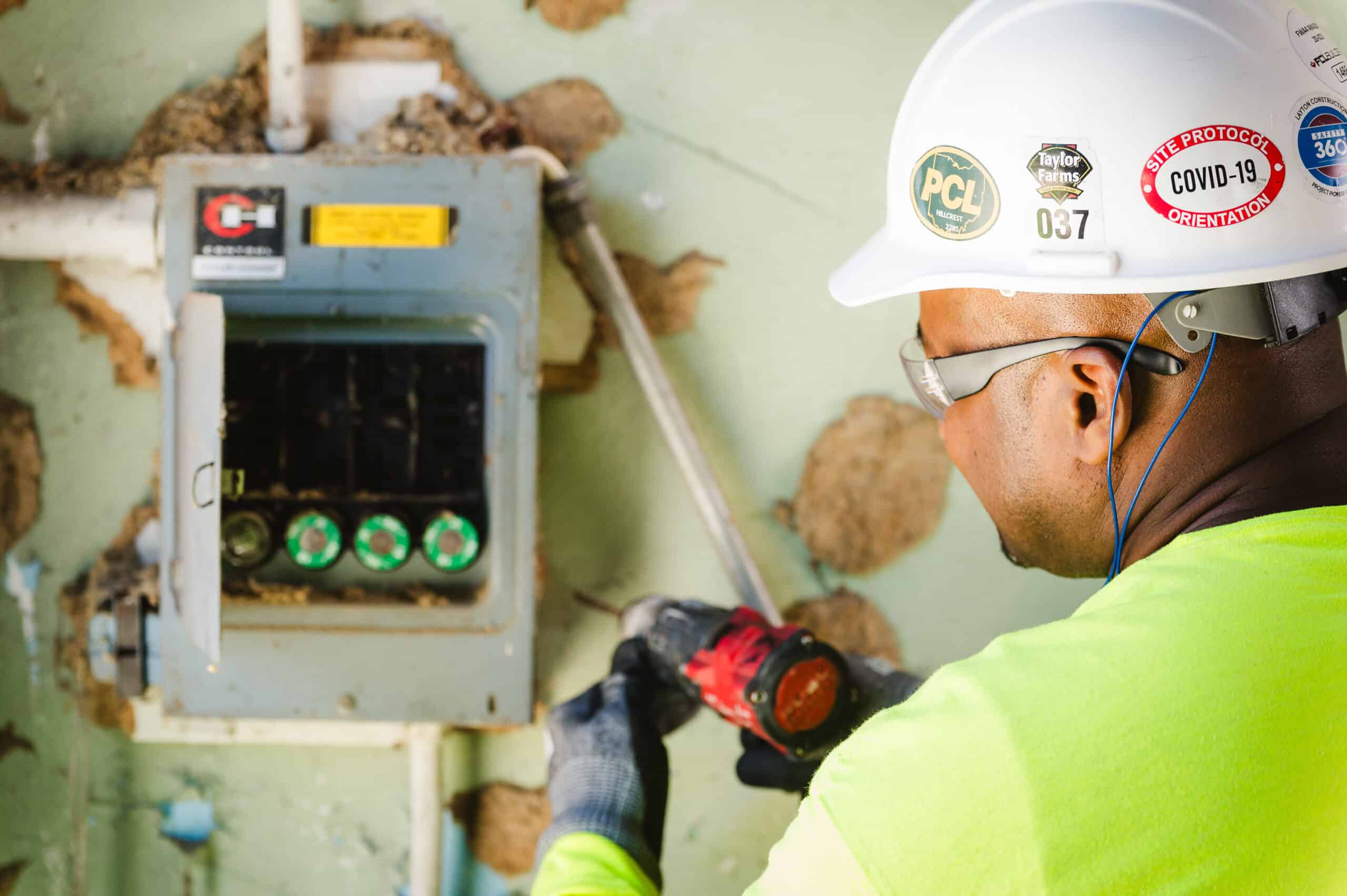 An electrical engineer works on electrical equipment on a job site