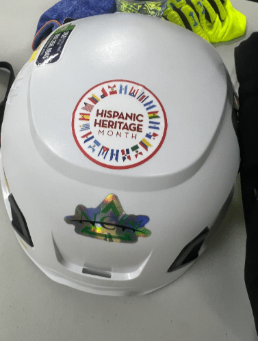 Hispanic heritage month sticker on a hard hat at a job site